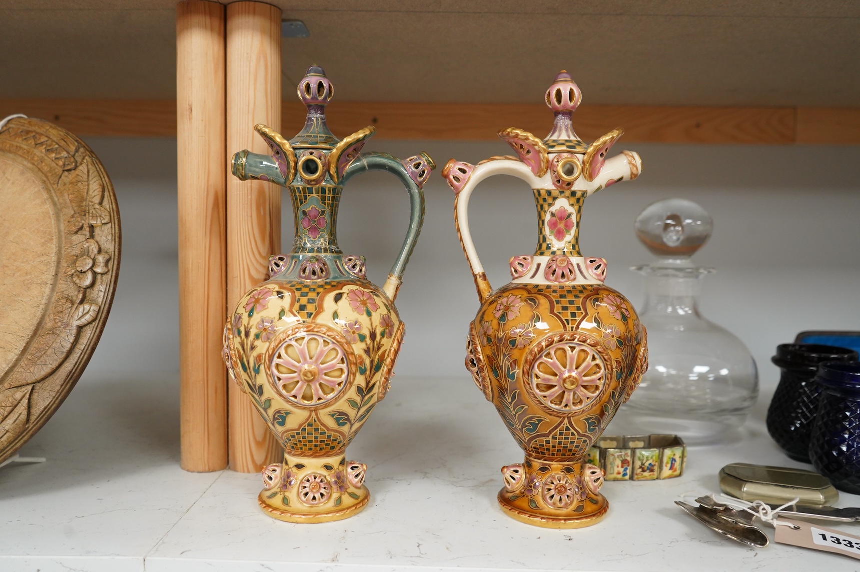 Two Zsolnay Persian inspired jugs / ewers and covers, stamped to the bases 29cm high